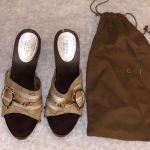 Gucci gold horsebit monogram sandals wooden heels.